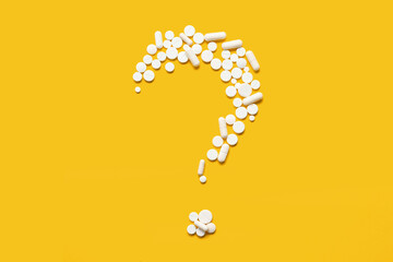 Question mark made of white pills on yellow background - obrazy, fototapety, plakaty