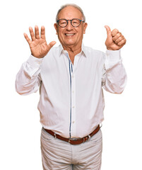 Senior caucasian man wearing business shirt and glasses showing and pointing up with fingers number six while smiling confident and happy.