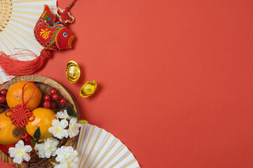 Fototapeta na wymiar Chinese New Year celebration with traditional decorations for Spring festival on red background. Top view, flat lay.