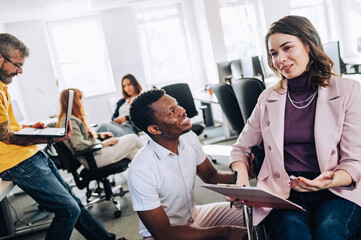 A diverse businesspeople discussing and planning project at office.
