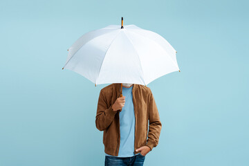 Man holding white stylish umbrella isolated on blue background 