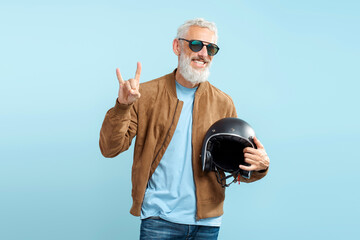 Handsome smiling mature man, cool gray haired biker wearing stylish sunglasses, brown leather...