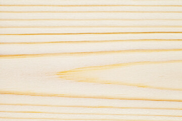 Surface of wooden board in close-up, uniform texture background, curved dark fibers, flat