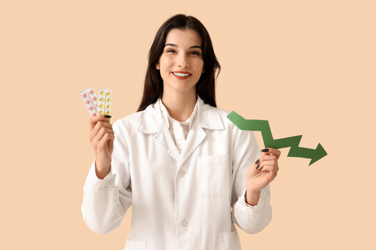 Female doctor with arrow and pills on beige background. Price decline concept