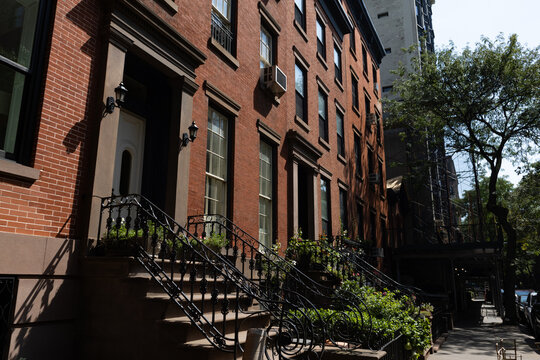 Row of Beautiful Old Brownstone Homes and Residential Buildings in Brooklyn Heights of New York City along the Sidewalk