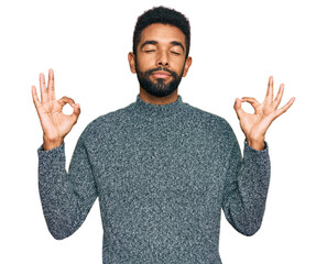 Young african american man wearing casual clothes relax and smiling with eyes closed doing meditation gesture with fingers. yoga concept.