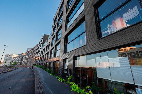 Row of Modern House Facades Along a City Walking Path