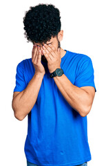 Young arab man with beard wearing casual blue t shirt rubbing eyes for fatigue and headache, sleepy and tired expression. vision problem