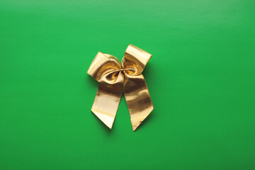 one golden bow on a green background