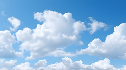 Naklejka na ściany i meble Fluffy white clouds scattered across a bright blue sky.