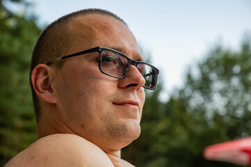Man in glasses with myopia outdoor 