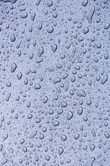 raindrops on the window in rainy days, abstract and blue background