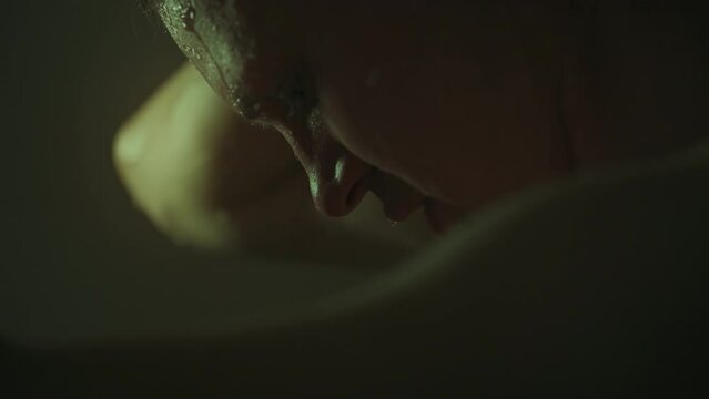 Taking a hot shower in his apartment, a man immerses himself in a relaxing atmosphere. Warm water caresses his skin, and dim light creates a feeling of comfort and safety.
