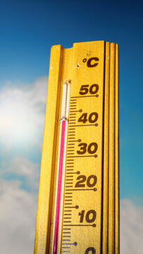 The thermometer displays a high heatwave temperature of 43 degrees Celsius. A red alarm gives a warning of the extreme weather conditions caused by global climate change on Earth. Hot summer season.