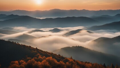 Naklejka premium sunrise view over the foggy mountains 