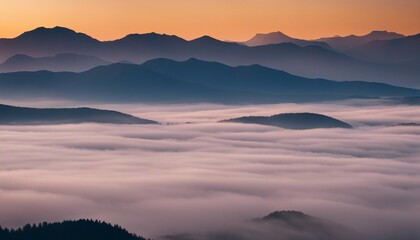 Obraz premium sunrise view over the foggy mountains 