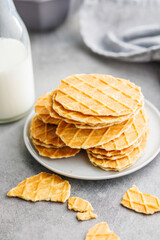 Round waffle biscuits on plate on kitchen table.