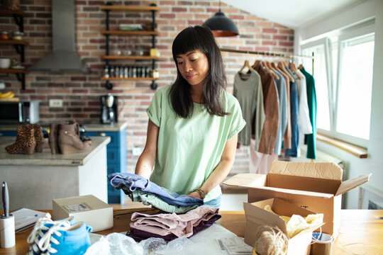 Young woman working in online store office packing shipment
