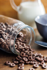 Sweet breakfast cereals in jar on kitchen table.