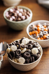 Sweet breakfast cereals in bowl on kitchen table.