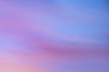 Naklejka na ściany i meble Sky with soft and fluffy pastel orange pink and blue colored clouds. Sunset background. Nature. sunrise.