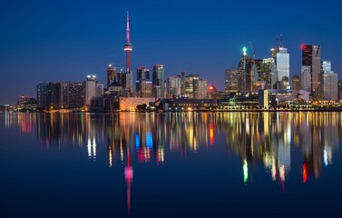Toronto at night with illuminated skyline from across the lake