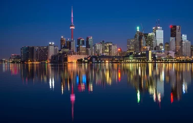 Tuinposter Toronto at night with illuminated skyline from across the lake © Wirestock