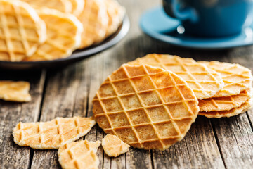 Round waffle biscuits on wooden table.