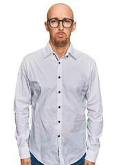 Bald man with beard wearing business shirt and glasses depressed and worry for distress, crying angry and afraid. sad expression.