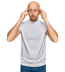 Naklejka premium Bald man with beard wearing casual white t shirt with hand on head for pain in head because stress. suffering migraine.