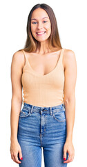 Fototapeta premium Beautiful brunette young woman wearing casual clothes looking positive and happy standing and smiling with a confident smile showing teeth