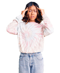 Obraz na płótnie Canvas Young beautiful mixed race woman wearing casual tie dye sweatshirt with hand on head for pain in head because stress. suffering migraine.