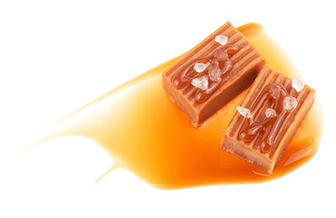 Salty caramel candies in milk caramel sauce with sea salt crystals isolated on a white background