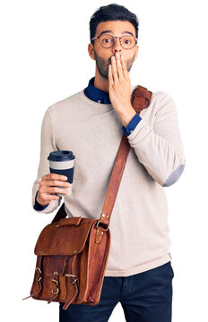 Young handsome hispanic man wearing leather bag and drinking take away coffee covering mouth with hand, shocked and afraid for mistake. surprised expression