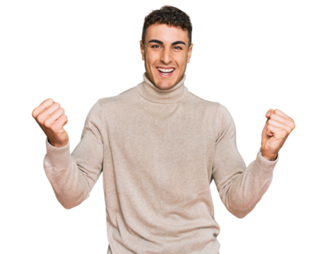 Hispanic young man wearing casual turtleneck sweater screaming proud, celebrating victory and success very excited with raised arms