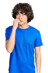 Caucasian teenager wearing casual clothes looking stressed and nervous with hands on mouth biting nails. anxiety problem.