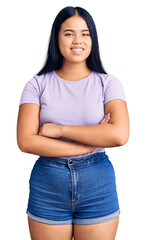 Fototapeta premium Young beautiful asian girl wearing casual clothes happy face smiling with crossed arms looking at the camera. positive person.