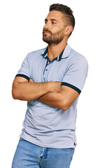 Fototapeta premium Handsome man with beard wearing casual clothes looking to the side with arms crossed convinced and confident