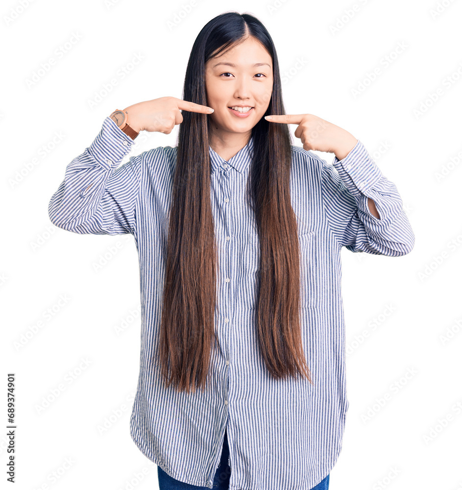 Sticker young beautiful chinese woman wearing casual shirt smiling cheerful showing and pointing with finger