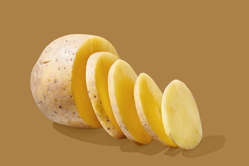 Potato slices on brown pastel background