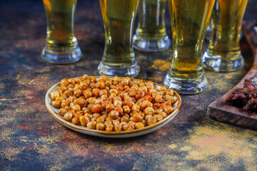 Beer glasses with different snacks.