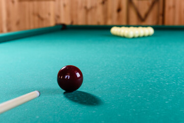 Close-up of cue and ball on the billiard table