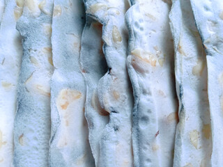 close up of uncooked mendoan tempeh. textured of tempeh or fermented soybeans for mendoan or traditional Indonesian snacks. mendoan for snacks or side dishes. food background