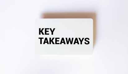 Eucalyptus leaves, an envelope and a white card with the text KEY TAKEAWAYS on a dark background.