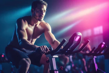 Türaufkleber Fit young man in sportswear riding a stationary bike during a cycling class at the gym. © FutureStock