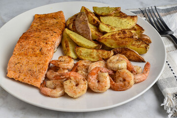 seasoned salmon  served with shrimp and potato wedges,