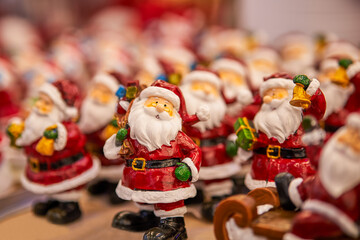 Fototapeta na wymiar Many toy Santa Claus Christmas background. Happy New Year and Xmas theme.