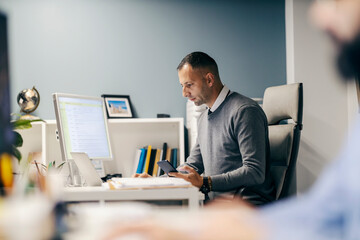 An accountant is sitting at office and calculating finances.