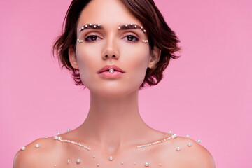 Photo of attractive stunning lady bite white pearls advertise jewelry store over pink color...