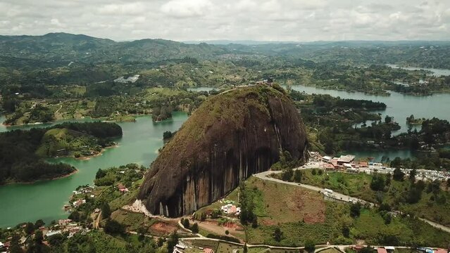 Aerial drone footage of El Penon de Guatape near Medellin in Antioquia, Colombia. Large and unique alone rock with stairs to the top, touristic place. Big stone in Colombia. High quality 4k footage.